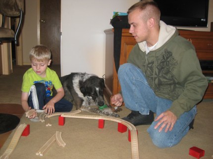 Little Friend and Younger Person building train tracks
