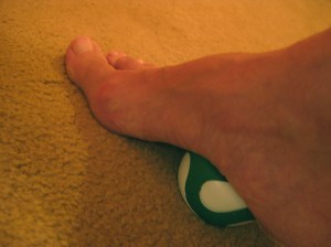 Foot stepping on a ball