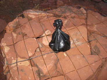 Little black bag on top of a cairn