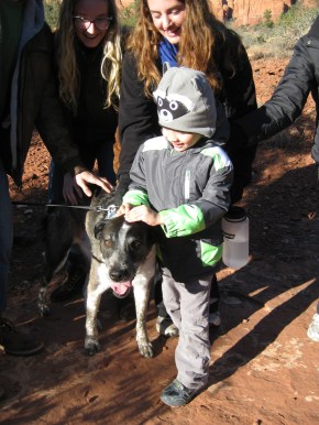 The boy with the raccoon hat patting Bongo's head