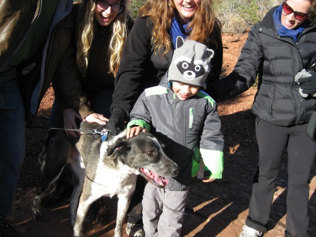The boy with the raccoon hat patting Bongo's head