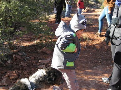The boy with the raccoon hat turning away from Bongo