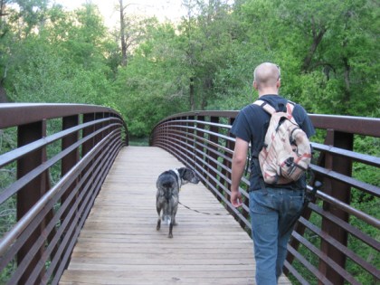 Bongo and his younger person walking across a bridge