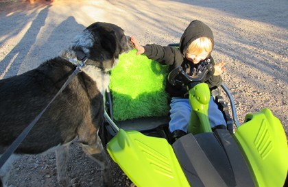 Boy holding Bongo at arm's length