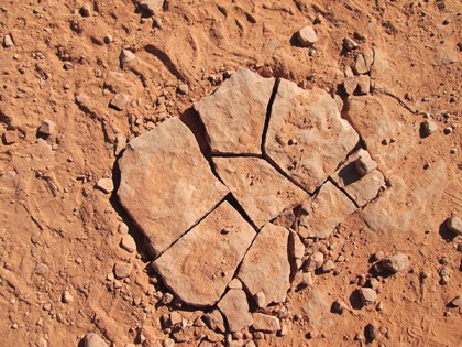 Red rock cracked into several pieces