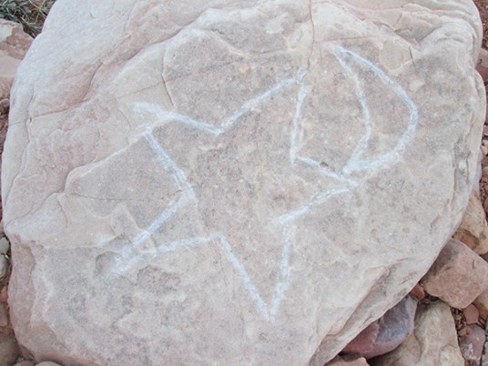A star and crescent moon drawn on a rock