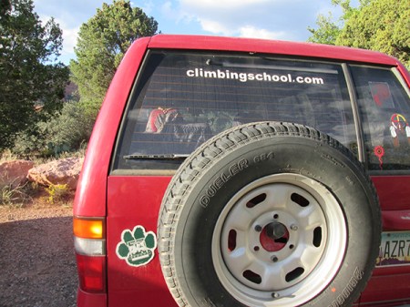 Red vehicle with paw and climbing school sign